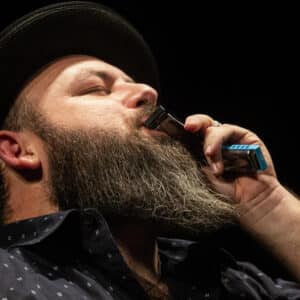 Brandon Santini playing harmonica